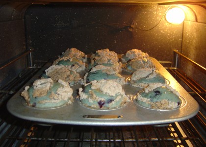 Blueberry-crumb muffins rising nice and high in the oven