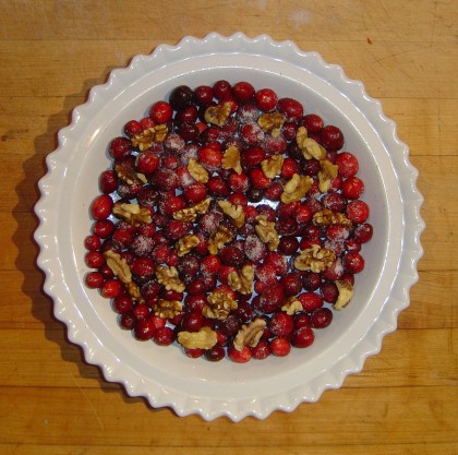 Cranberries sprinkled with sugar and walnuts, waiting for the batter to be spooned on top for Nantucket Cranberry Pie