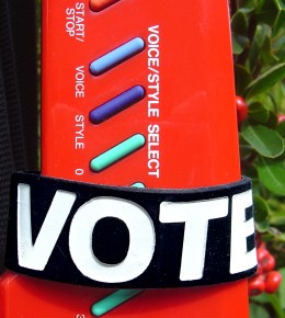 an 'I Voted' wristband from Rock the Vote being modeled by a Yamaha keytar