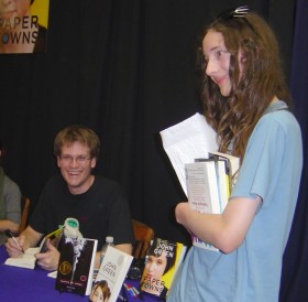 John Green autographs Arthur's copies of his books