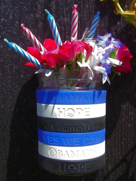 My Obama 2008 campaign 'Yes We Can' and 'Hope' wristbands with flowers and candles for President Obama's 50th birthday